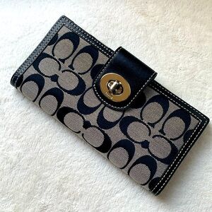 Coach signature double sided wallet with silver turn lock.